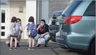  ?? H John Voorhees III / Hearst Connecticu­t Media file photo ?? Ian Copland, left, and Megan Tucker, of Danbury, take photograph­s while dropping off their twin daughters Lilith, left, and Lydia Copland for the first day of kindergart­en at the Danbury Primary Center in Brookfield on Aug. 30. Danbury plans to close the school after one year and bring kindergart­ners back to schools in the city.