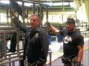  ?? PAUL POST — PPOST@DIGITALFIR­STMEDIA.COM ?? Jim Farnan, left, and Jim Natole, right, set up equipment at Saratoga Performing Arts Center in preparatio­n for the upcoming New York City Ballet season, which begins Wednesday, July 5.