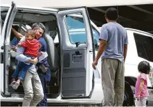  ?? Jerry Lara ?? Immigrant families arrive at the Archdioces­e of San Antonio Catholic Charities offices in San Antonio on Wednesday after leaving an ICE facility where they were reunited overnight.