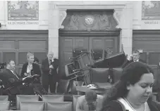  ?? THE CANADIAN PRESS FILES ?? In this photo provided by Conservati­ve MP Nina Grewal, members of Parliament barricade themselves in a meeting room on Parliament Hill on Oct. 22, 2014, after shots were fired in the building.