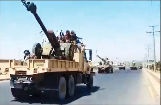  ?? ?? ADVANCED WEAPONRY: Taliban fighters aboard US military trucks carrying heavy artillery on their way to fight rebels in the Panjshir Valley