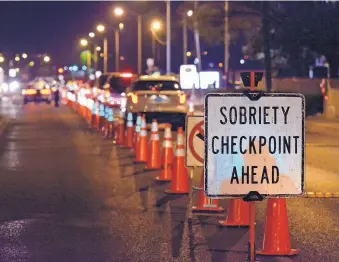  ?? JIM THOMPSON/JOURNAL ?? Vehicles head toward a DWI checkpoint on Montgomery Blvd.