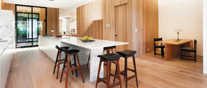  ?? Photos by Reflex Imaging ?? Above: The kitchen of 1864 Greenwich St. offers Calacatta marble counters with waterfall edges, Arclinea cabinetry and Miele appliances. A built-in table also creates a quaint breakfast space. Below: The four-level Cow Hollow contempora­ry is available...