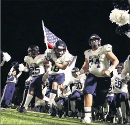  ?? PHOTO BY TREVOR STAMP ?? Aquinas charges onto the field before taking on Glendora in a CIF Southern Section Division 5 football semifinal game at Citrus College on Nov. 22, 2019. The Falcons will finally get to take the field again in an official game Friday against Paraclete.