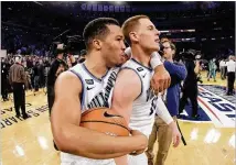  ?? FRANK FRANKLIN II / AP ?? Villanova’s Jalen Brunson (left) celebrates with Donte DiVincenzo after the team’s 76-66 overtime victory against Providence on Saturday to win the Big East Tournament. The Wildcats earned a No. 1 seed Sunday in the NCAA Tournament.