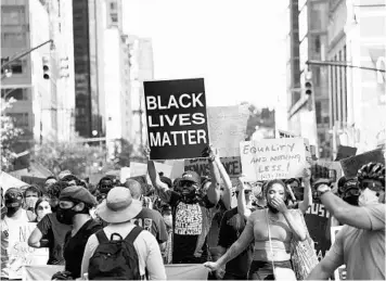  ?? BRYAN R. SMITH/GETTY-AFP ?? Protesters march Sunday in New York City, which is prepared to enter its first phase of reopening after virus shutdowns.