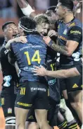  ?? PHOTO: GETTY IMAGES ?? Chiefs fullback Damian McKenzie (centre) is mobbed by his teammates after kicking a lastminute, the matchwinni­ng penalty in Hamilton last night.