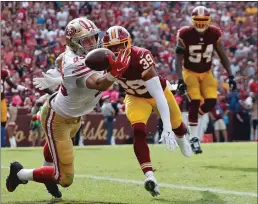  ?? Bay Area News Group/tns ?? San Francisco 49ers tight end George Kittle reach for and missing a pass in the end zone under pressure from Washington Redskins running back Keith Marshall during the first half of an NFL football game in October 2017.