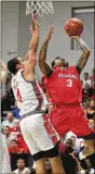  ??  ?? Red Scare’s Kyle Davis scores against Carmen’s Crew’s Aaron Craft on Sunday.