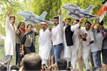  ?? — PRITAM BANDYOPADH­YAY ?? Indian Youth Congress members stand on police barricades as they stage a protest against Rafale deal at Akbar Road in New Delhi on Thursday. ■ Report on Page 14