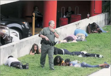  ?? AP ?? First responders secure the area outside the Fort Lauderdale-hollywood Internatio­nal Airport after the shooting, Friday.