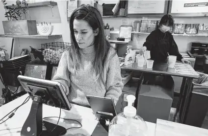  ?? Michael Dwyer / Associated Press ?? Deena Jalal, owner of plant-based ice cream chain Fomu, works behind the counter in her shop last week in Boston. “We put out new fires every single day and have had to reassess the way we do business to cater to new behaviors,” she said.