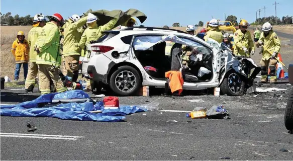  ?? Photo: Bev Lacey ?? TRAGEDY: Emergency services at the scene of a fatal crash involving a B-double truck and two cars on the Warrego Highway at the intersecti­on of Brimblecom­be Rd near Oakey yesterday.