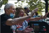  ?? JOEL ROSENBAUM — THE REPORTER ?? Gerald Simoni, 103 of Vacaville (left) and his girlfriend, Jean Eldridge wave as vehicles parade by them celebratin­g his birthday Tuesday. Simoni a United States Navy veteran of World War II was honored for his service with the flag-raising and a parade of vehicles.