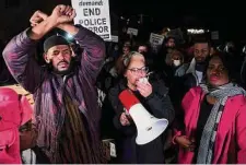  ?? Patrick Lantrip/Associated Press ?? Protesters lead chants of “hands up, don’t shoot” Friday while blocking traffic on the Interstate 55 bridge in Memphis, Tenn.