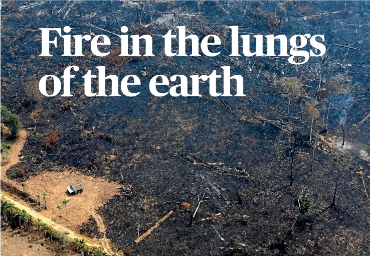  ?? AP ?? Land scorched by wildfires surrounds a solitary house near Porto Velho, a city in the heart of the Brazilian Amazon. Thousands of fires are burning across a vast expanse of rainforest.