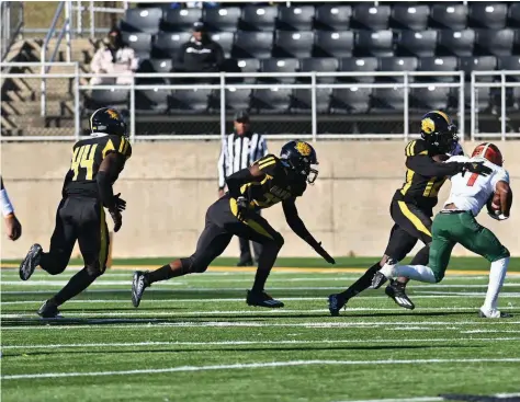  ?? (Special to The Commercial/Darlena Roberts) ?? UAPB defensive back Nathan Seward tackles Florida A&M running back Bishop Bonnett in the open field Saturday at Simmons Bank Field at Golden Lion Stadium.