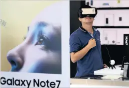  ??  ?? A man tries out the Samsung VR using their latest Galaxy Note 7 at a roadshow outside a shopping mall in Beijing yesterday. Two Samsung Galaxy Note 7 smartphone­s reportedly have caught fire in China in seperate incidents.