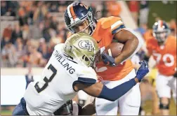  ?? Amber searls/usa Today sports ?? Virginia Cavaliers running back Devin Darrington (26) carries the ball as Georgia Tech Yellow Jackets defensive back Tre Swilling (3) defends during the fourth quarter at Scott Stadium.