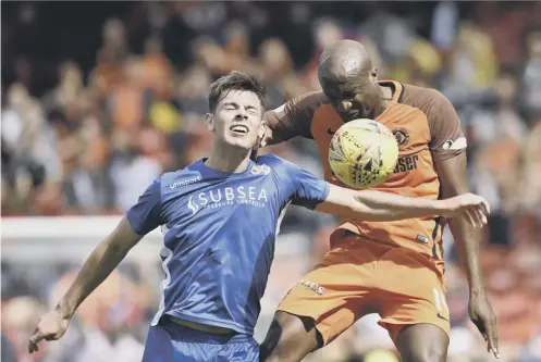  ?? PICTURE: ROB CASEY/SNS ?? 0 Dundee United’s William Edjenguele challenges Cameron Muirhead during yesterday’s game.