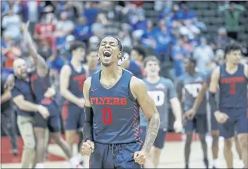  ?? PHOTOS BY JACOB M. LANGSTON — THE ASSOCIATED PRESS ?? Dayton guard Elijah Weaver celebrates their win over Kansas on Friday in Lake Buena Vista, Fla.