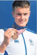  ??  ?? Medal joy : Marc Austin shows off his Commonweal­th bronze