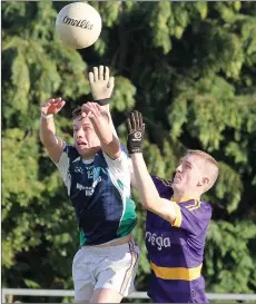  ??  ?? Aaron McGuire (Volunteers) beats Joe Cousins in the air.