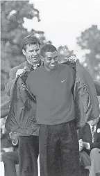  ?? PORTER BINKS/ USA TODAY ?? Masters champion Tiger Woods receives his green jacket from the previous year’s winner, Nick Faldo, on April 13, 1997.