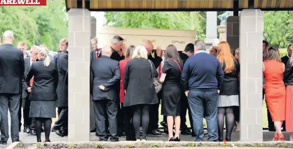  ??  ?? Goodbye Mourners line the entrance to the crematoriu­m as Leighanne’s coffin arrives