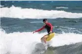  ?? JOE CAVARETTA/STAFF PHOTOGRAPH­ER ?? Luis Restrepo of Boca Raton gets a ride Sunday at South Ocean Park as winds and waves kicked up.