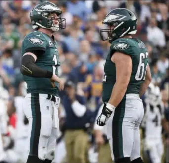  ?? THE ASSOCIATED PRESS FILE ?? Eagles center Jason Kelce, right, spends a calm moment with quarterbac­k Carson Wentz Sunday in Los Angeles, before Wentz went down with a season-ending knee injury. Kelce didn’t go down after getting spiked at practice Thursday ... he just went off.