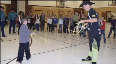  ??  ?? Rodeo clown JJ Harrison shows off his roping skills as part of a tour of cowboys that visited Spanish Fork elementary schools and Nebo School District junior high schools. The visitors encouraged students not to bully others.