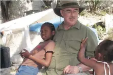  ?? STEVE ADAMS ?? Retired Langford fire chief Bob Beckett with children from the orphanage in Port-au-Prince, Haiti, in 2011.