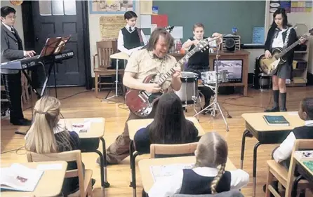  ?? PARAMOUNT PICTURES ?? Jack Black leads private school kids through some unconventi­onal lessons in Richard Linklater’s “School of Rock” (2003).