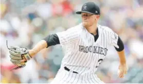  ?? Matthew Stockman, Getty Images ?? Rookie left-hander Kyle Freeland, pitching Sunday against the Pirates at Coors Field, improved to 10-7 and lowered his ERA to 3.64.