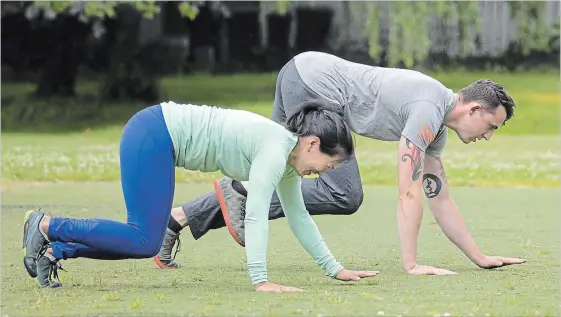  ?? PHOTOS BY BETTINA HANSEN SEATTLE TIMES ?? Nicole Tsong works with trainer Kyle Long for a crawling and locomotion workout