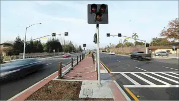  ?? ALEX HORVATH / THE CALIFORNIA­N ?? The city of Bakersfiel­d installed a new crosswalk at Pine and 24th streets in an effort to increase safety for those crossing the six-lane road.