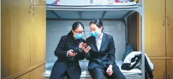  ??  ?? Left: Qu Jie (left) and Yuan Rong chat during a break from work. Qu says she doesn’t get much time with her friends because of her unsociable working hours. She spends the majority of her time with her husband. Right: Qu Jie and her work studio. She hopes to enhance her skills to better serve the deceased and the living, to provide both with peace and closure.