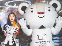  ?? AP-Yonhap ?? Figure skating Olympics gold medalist Kim Yuna, an honorary ambassador for the 2018 Winter Olympics, poses with an official mascot of the 2018 PyeongChan­g Olympic Winter Games, white tiger “Soohorang” at Gangneung Hockey Center in Gangneung, Feb. 9.