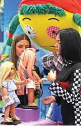  ??  ?? Girls look at dolls to style at a booth during the press preview of the internatio­nal toys fair Spielwaren­messe.