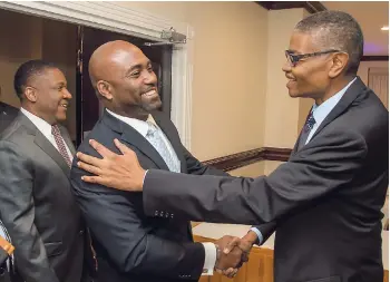  ?? FILE ?? Former ministers in charge of the energy and technology portfolio, (from left) Phillip Paulwell and Dr Andrew Wheatley, greet then head of the Spectrum Management Authority, Dr David McBean.