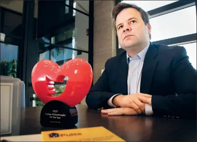  ?? (AP/The Palm Beach Post/Lannis Waters) ?? Bill Pulte is interviewe­d Dec. 13 with the Twitter Philanthro­pist of the Year trophy on a desk in front of him in his offices in Boca Raton, Fla.