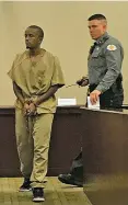  ?? PHAEDRA HAYWOOD/NEW MEXICAN FILE PHOTO ?? Daniel Tadege is led to the podium during his plea hearing in June in District Court in Santa Fe.