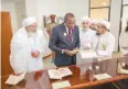  ??  ?? The President surveys rare handwritte­n manuscript­s displayed in the library. The library is spread over four floors.