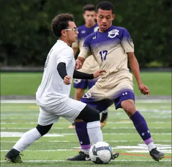  ?? Photo by Jerry Silberman / risportsph­oto.com ?? St. Raphael defender Edgardo Cardona (17) attempts to slow down Cranston East midfielder Garbiel Sotelo (6) during the Saints’ impressive 3-1 victory over the first-place Thunderbol­t Monday at Cranston Stadium.