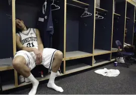  ?? AP FILE ?? BUMMED OUT: Connecticu­t's Josh Boone sits in the locker room after his team's 86-84 overtime loss to George Mason in the NCAA basketball tournament regional championsh­ip game in Washington in 2006.