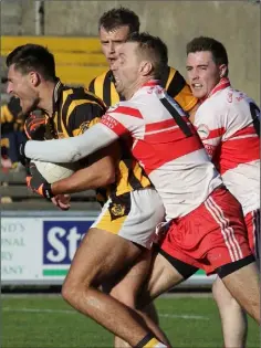  ??  ?? Glen Malone of Shelmalier­s is tackled by Kilan erin’s Matty Forde.