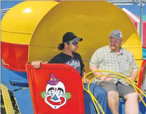  ?? ERIC MCCARTHY/JOURNAL PIONEER ?? Prince County Exhibition president Jason Rayner, right, is shown with Hinchey’s Rides and Amusements’ midway worker Kenny “Ducky” Earle. Earle revealed that the Tilt-a-whirl was his favourite ride when he was a kid and now he gets to operate the ride....