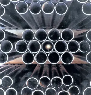  ?? PHOTO COURTESY OF IPSCO ?? Stack of tubular metal pipes at an IPSCO facility.