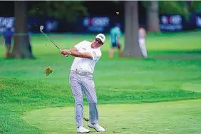  ?? CARLOS OSORIO/ASSOCIATED PRESS ?? Phil Mickelson is shown hitting onto the 13th green during Friday’s second round of the Rocket Mortgage Classic. He is upset about the timing of a Detroit News story in a past gambling incident, even though his attorney says the reporting is accurate.